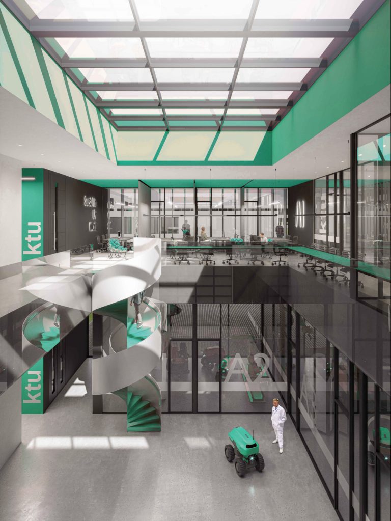 Bright, modern interior of the AI Centre SustAInLivWork, featuring a large skylight, glass-walled meeting rooms, and a green-accented spiral staircase. A small autonomous robot vehicle is on the polished concrete floor near a person in white, with “SustAInLivWork” displayed on the back wall, highlighting the centre’s focus on sustainable AI-driven living and working solutions.