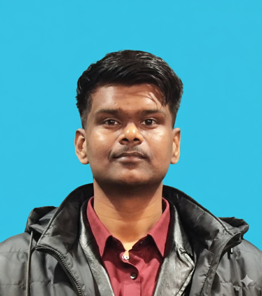 Headshot of a man wearing a maroon button down shirt and black jacket against a solid blue background. He faces the camera with a neutral expression, making this a clear professional profile photo.